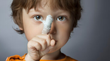 boy with a bandaged wound on his finger (focus on finger)