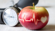 Heartbeat line on red apple and sphygmomanometer, healthy heart