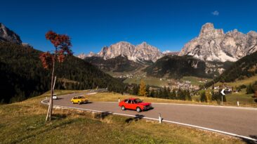 Oct. 2018, Alta Batia, Hochabteital, Dolomiten, Suedtirol, Italien, Classic car oldtimer in autumn on a pass road with blue sky