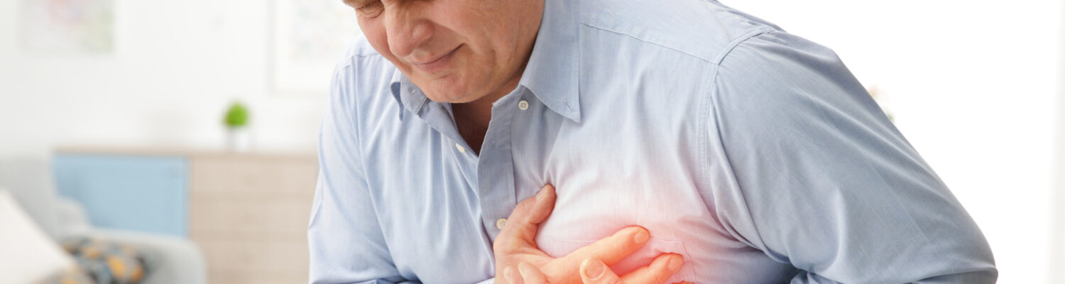 Man with chest pain suffering from heart attack in office