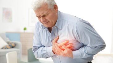 Man with chest pain suffering from heart attack in office