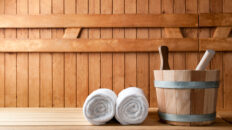 Detail of bucket and white towels in a sauna