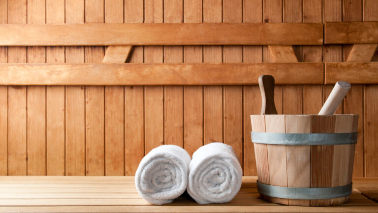 Detail of bucket and white towels in a sauna