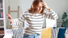 Young woman suffering from vertigo or dizziness problem of brain or inner ear