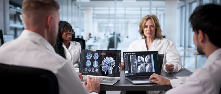 Neurologist At Hospital Analyzing Brain Scan On Computer Screen Carefully.